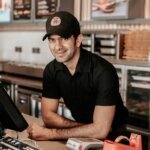 Waiter serving guests in a professional restaurant in Saudi Arabia